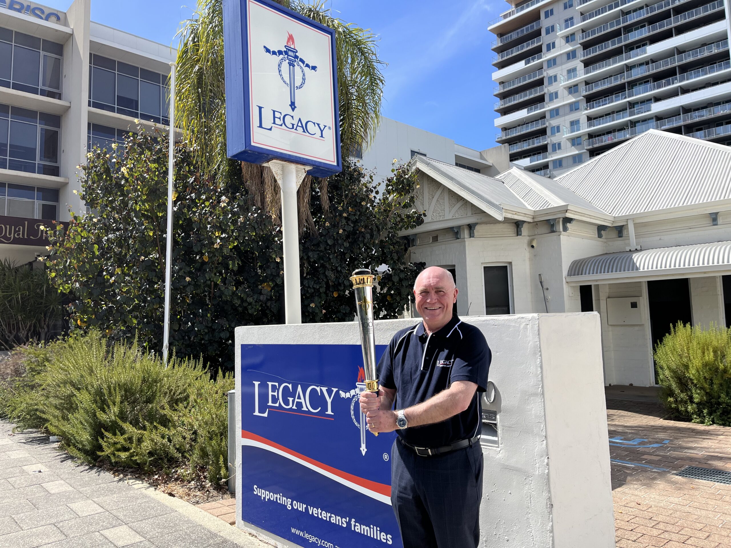 CEO of Legacy WA Matt Granger hold the torch for the Legacy Centenary Torch Relay